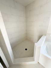 Full bath featuring a garden tub and tiled shower