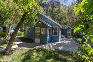 View of front of house with a patio and a front lawn