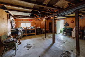 Basement featuring a workshop area and wood walls