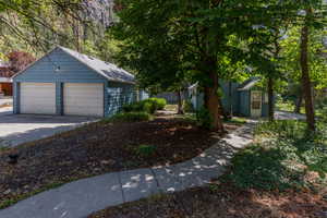 View of home's exterior with an outbuilding and a detached garage