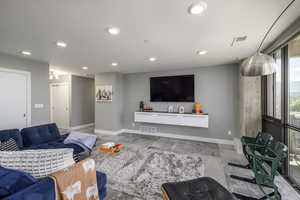 Living area with baseboards and recessed lighting