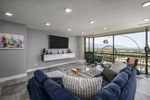 Living area with floor to ceiling windows and recessed lighting