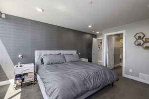 Bedroom with carpet floors, recessed lighting, and wallpapered walls