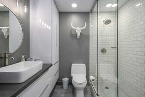 Full bathroom with a stall shower and vanity