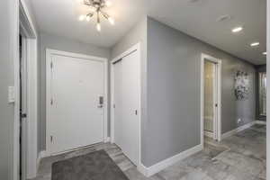 Entrance foyer featuring a chandelier and recessed lighting