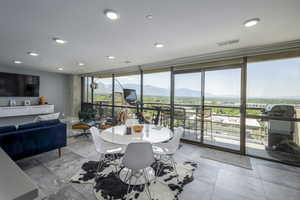 Dining space with a wall of windows and a mountain view
