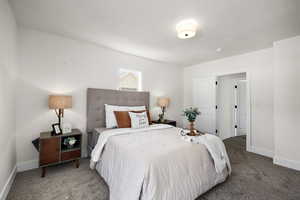 Bedroom with carpet floors and a textured ceiling
