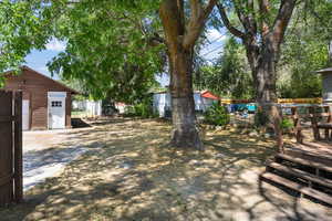 View of yard featuring an outbuilding and a deck