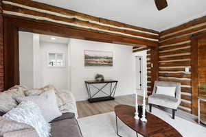 Living area featuring wood finished floors and rustic walls