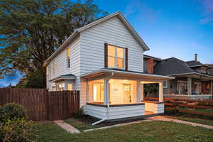 Traditional style home featuring covered porch and a shingled roof