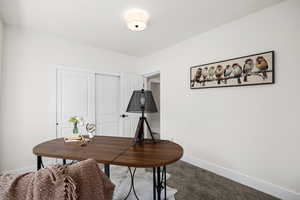 Carpeted office featuring baseboards