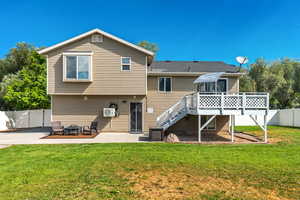 Rear view of house with stairs, a deck, and a patio