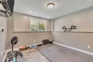 Workout room featuring recessed lighting and wood finished floors