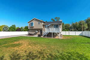 Back of property featuring stairway, a fenced backyard, a deck, and a patio