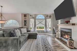 Living area featuring wood finished floors and a fireplace