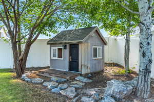 View of shed with a fenced backyard