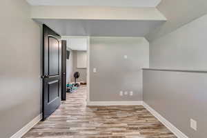 Spare room featuring wood finished floors and baseboards
