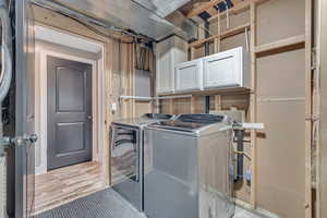 Laundry room featuring cabinet space and independent washer and dryer