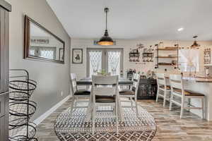Dining area with light wood finished floors, plenty of natural light, and recessed lighting