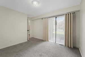 Unfurnished room with carpet flooring