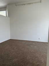 Empty room with dark colored carpet