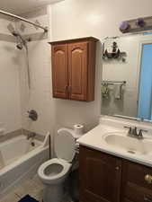 Bathroom featuring vanity, tile patterned flooring, and washtub / shower combination