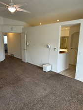 Carpeted empty room featuring a ceiling fan, lofted ceiling, recessed lighting, and tile patterned flooring
