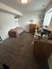 Carpeted bedroom featuring baseboards