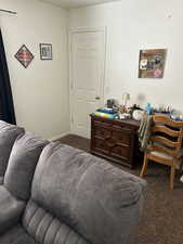 Living room with carpet floors and a desk