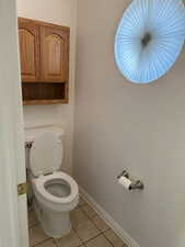 Bathroom featuring light tile patterned floors and toilet