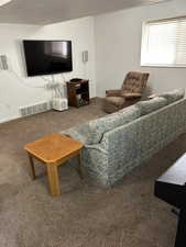 Carpeted living area with baseboards