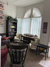 Carpeted living area featuring tile patterned floors