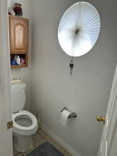 Bathroom featuring toilet and tile patterned flooring