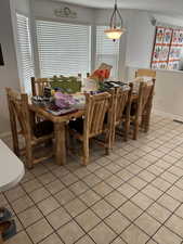 Dining room featuring light tile patterned floors and baseboards