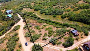 Aerial view of sparsely populated area featuring property boundaries highlighted