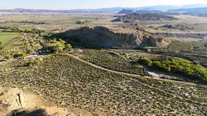 Aerial view of property and surrounding area with rural landscape and a mountain backdrop