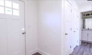 Entryway with wood finished floors and baseboards