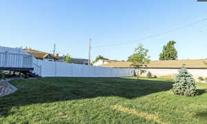 View of yard featuring a wooden deck and stairway
