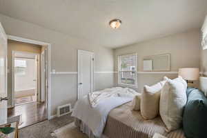 Bedroom featuring carpet flooring and baseboards
