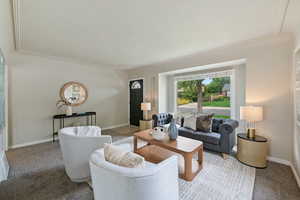 Carpeted living area with baseboards