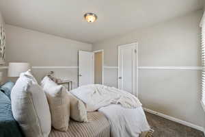 Bedroom with carpet floors and baseboards