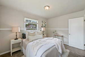 Carpeted bedroom featuring baseboards