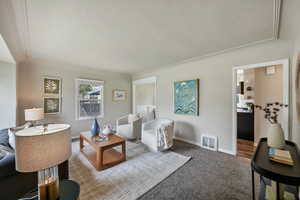 Living area with carpet floors and baseboards