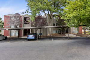 View of property featuring covered parking