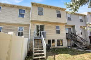 Rear view of property featuring stairway