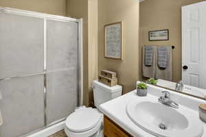 Full bathroom featuring vanity and a shower stall