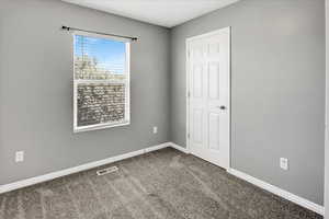 Unfurnished bedroom with carpet and baseboards