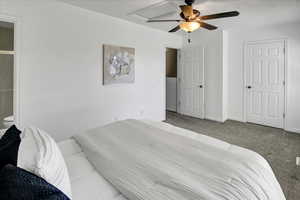 Carpeted bedroom featuring ceiling fan and baseboards