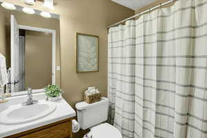 Full bathroom with vanity and a shower with shower curtain