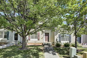 Obstructed view of property featuring a front lawn